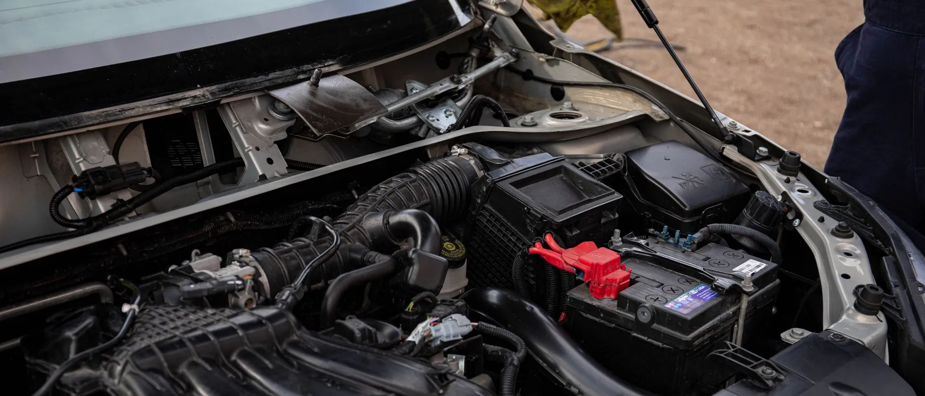A clean engine bay under the open hood of a used car