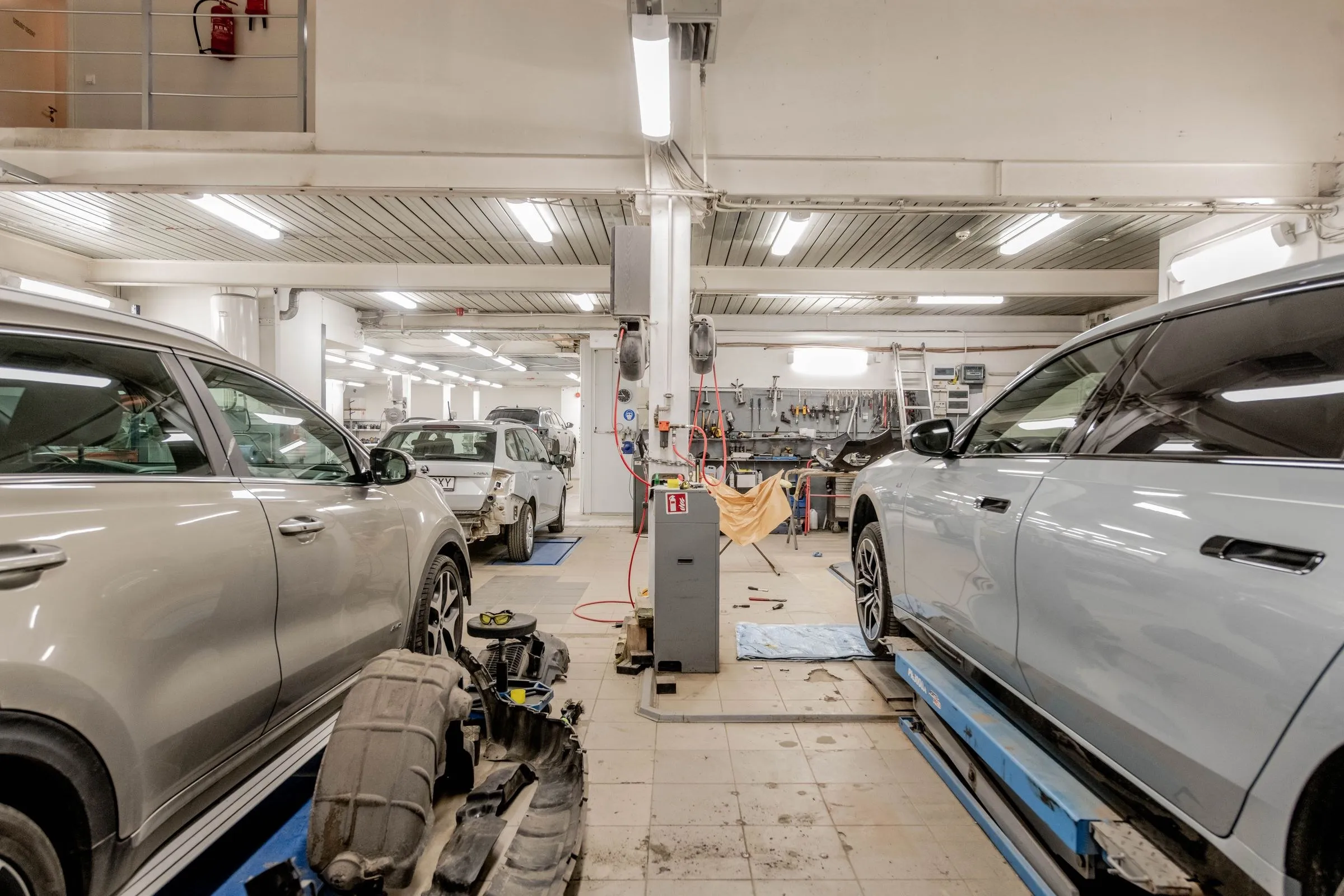 A car on a lift in a working service bay